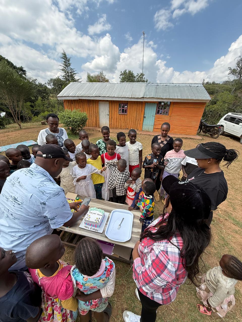 Children gather around a birthday cake at a Soul Food Session